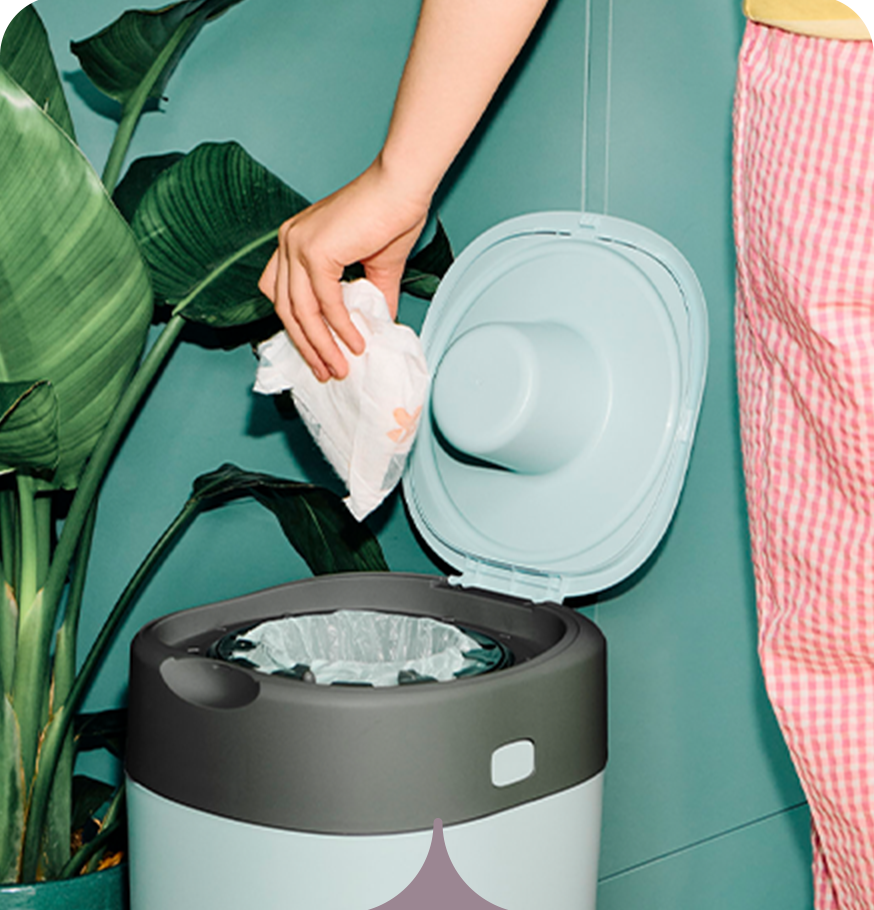 A mum dropping a nappy into a Twist & Click bin from Tommee Tippee 