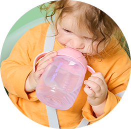 a baby feeding from a tommee tippee bottle