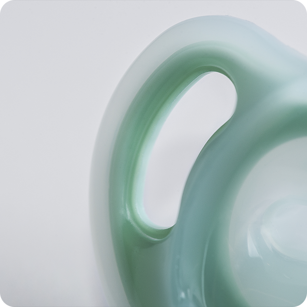 A close up of a blue Ultra-light soother from Tommee Tippee. 